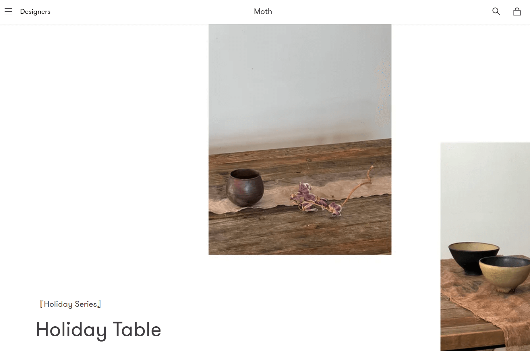shopify general store: A rustic wooden table with a brown ceramic cup and dried flowers on a beige cloth runner; two bowls sit on a cloth to the right. The scene is minimal and earthy, styled for a holiday table setting.