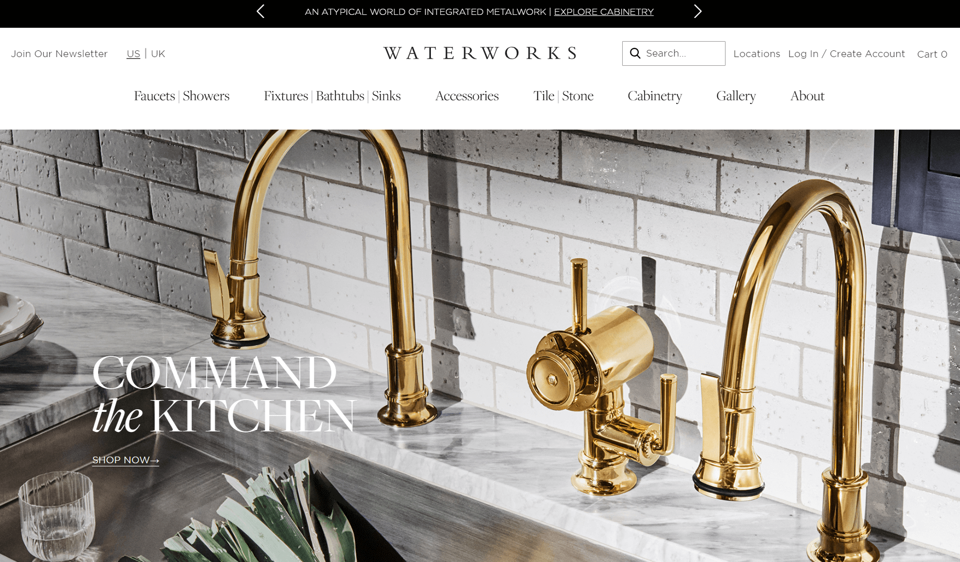 Waterworks kitchen banner with polished brass faucets against white tile backsplash