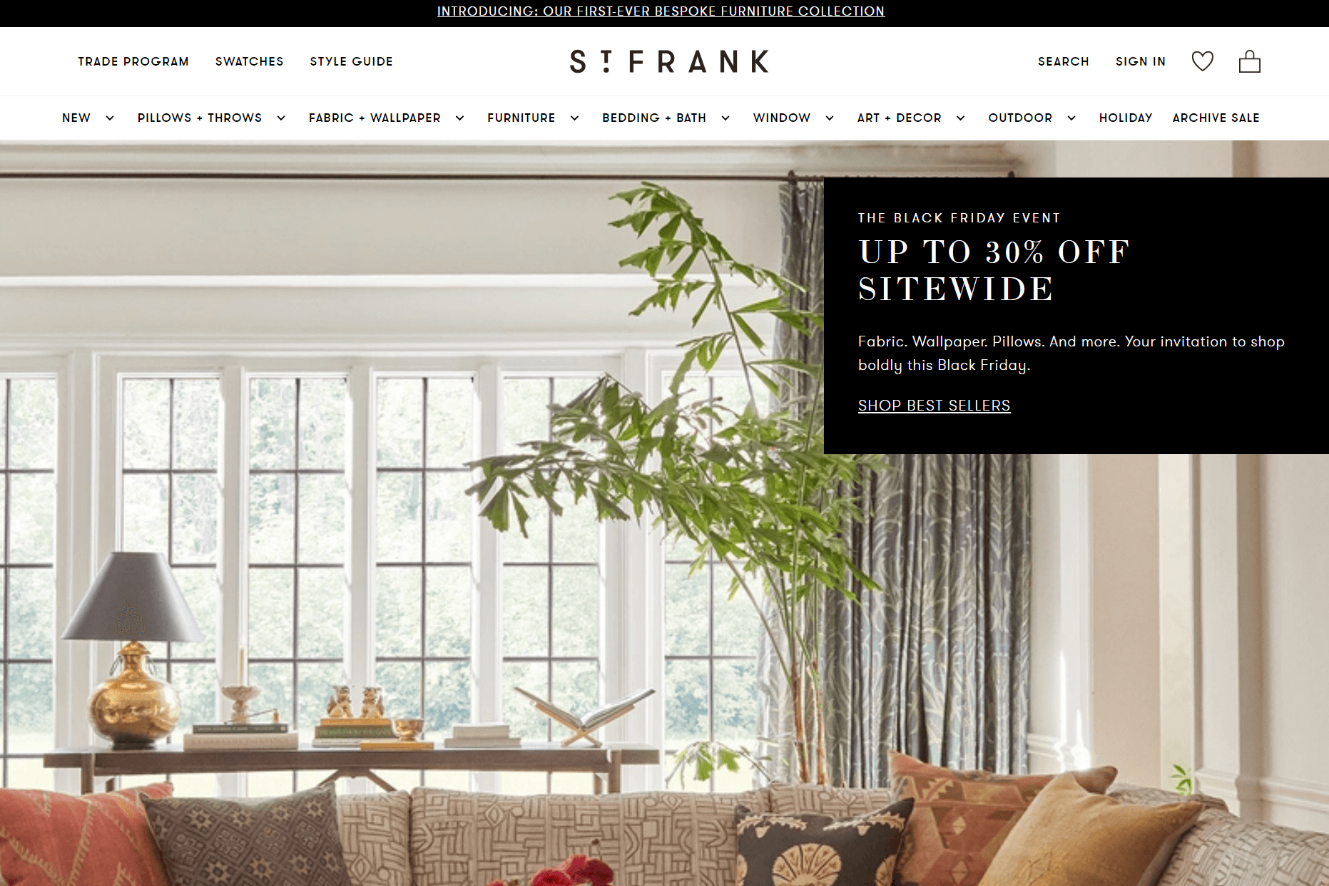 shopify general store: A cozy living room with a beige couch, assorted patterned pillows, a large green plant, and a coffee table sits in front of tall windows. Overlaid text advertises a Black Friday sale for up to 30% off sitewide at St. Frank.