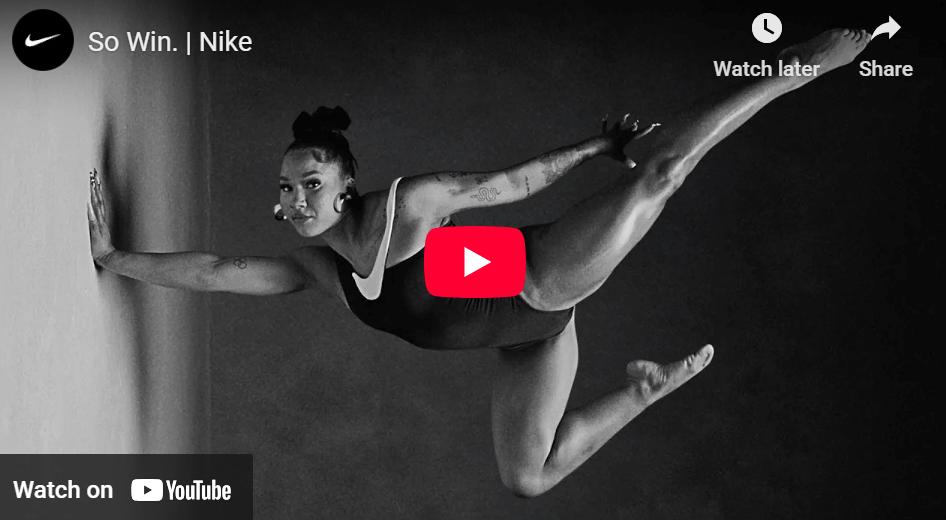 Marketing campaigns: A woman in an acrobatic outfit standing on one hand, looking confidently at the camera. 