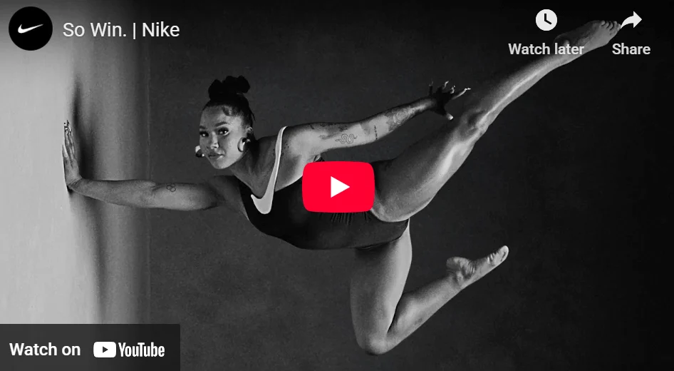 Marketing campaigns: A woman in an acrobatic outfit standing on one hand, looking confidently at the camera.