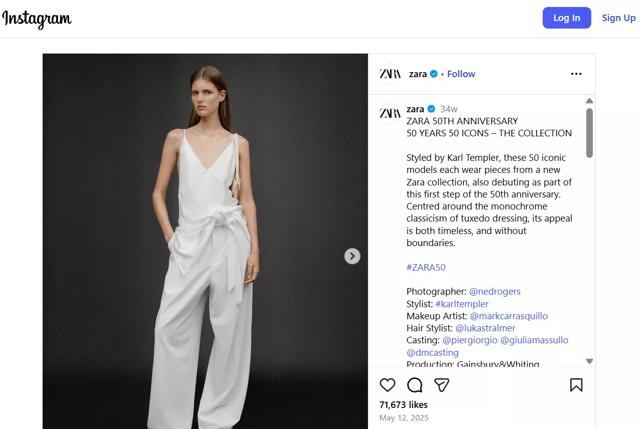 Marketing campaigns: A woman stands against a dark backdrop wearing an elegant, sleeveless white jumpsuit with a deep V-neck and wide-leg pants, modeling for Zara’s 50th Anniversary Collection.