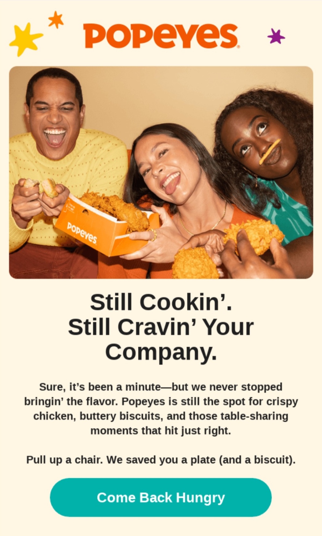Email marketing examples: Three smiling people share Popeyes fried chicken and biscuits, holding food and laughing together. The background is light with colorful stars, and the Popeyes logo is displayed above a welcoming message and a Come Back Hungry button.