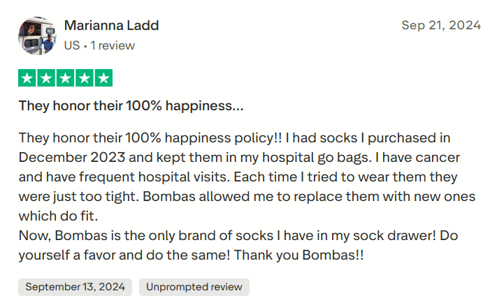 Shopify stores: Screenshot of a 5-star Trustpilot review by Marianna Ladd praising Bombas for their happiness policy and comfort during hospital visits, especially for a cancer patient. Includes review date and user buttons for September 13, 2024 and Unreported content.