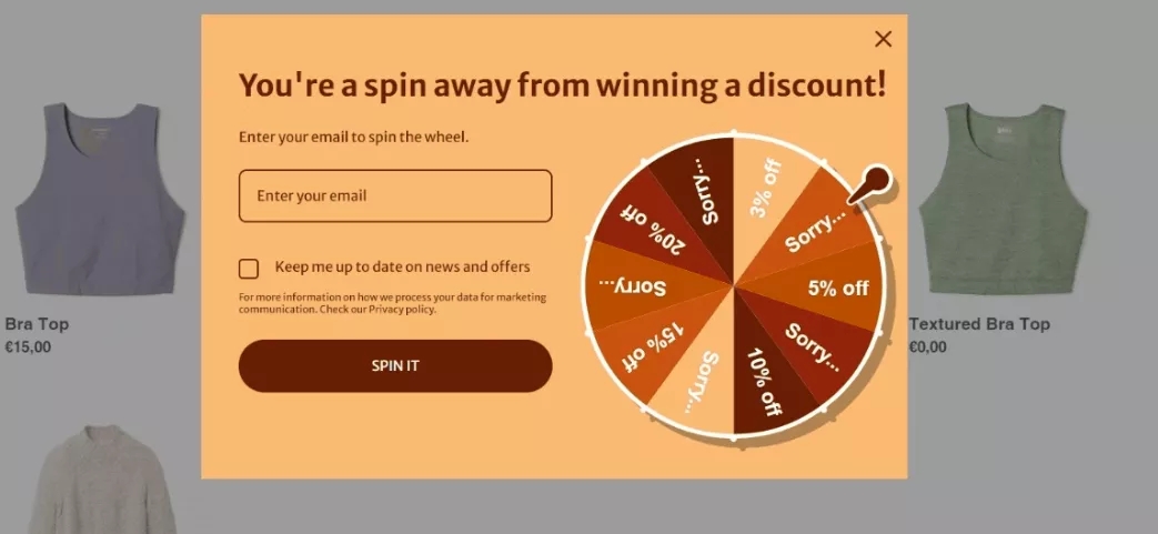 Omnisend vs. Shopify: A pop-up on a shopping website offers a chance to win a discount by spinning a wheel after entering an email. The wheel displays sections for 20% off, 10% off, 5% off, and several Sorry! slots.