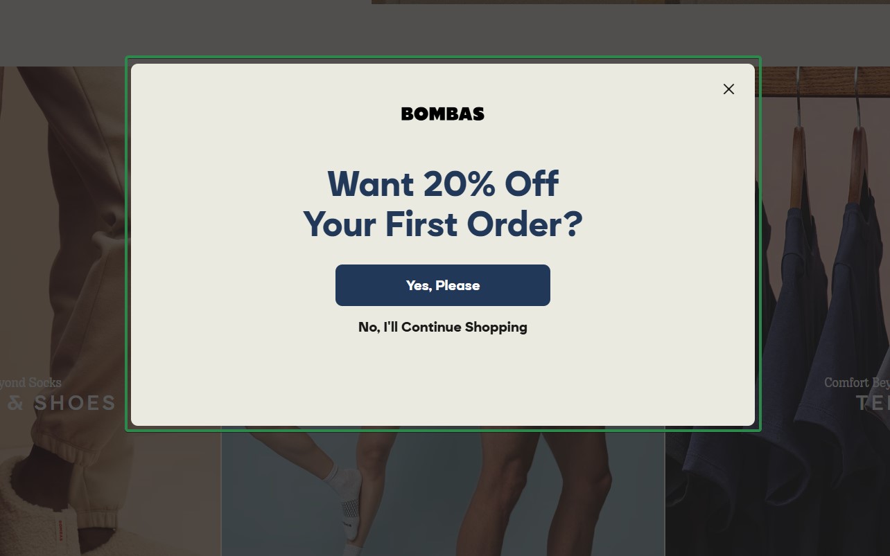 Shopify newsletter: A pop-up ad on the Bombas website offers 20% off the first order with two buttons: Yes, Please and No, Ill Continue Shopping. The background shows partially visible clothing images.
