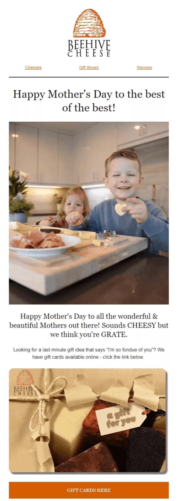 Mother's Day email examples: A boy and girl smile at a table with cheese and drinks, part of a Mother’s Day greeting from Beehive Cheese, featuring a cheese gift card below.