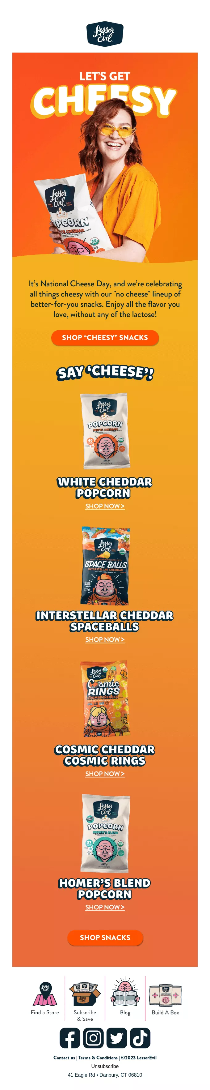 June newsletter ideas: A woman in an orange shirt holds a bag of popcorn. Text promotes National Cheese Day and features five flavors of cheesy popcorn, each shown in a bag: White Cheddar, Buffalo Cheddar, Blazin Hot Cheddar, Cosmic Cheddar, and Hornet Blend.