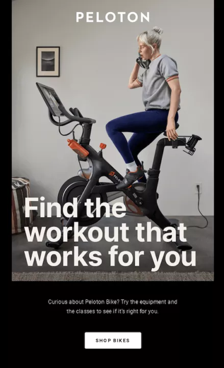 May newsletter ideas: A person with short gray hair rides a Peloton exercise bike indoors, talking on the phone. Text reads, Find the workout that works for you. A button below says, Shop Bikes.