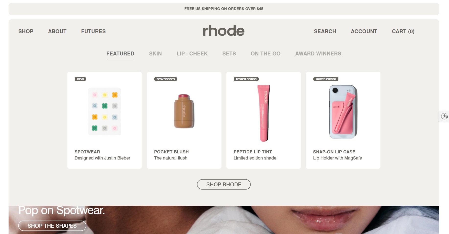 Ecommerce website examples: Screenshot of the rhode website featuring four products: Spotwear patches, Pocket Blush, Peptide Lip Tint, and Snap-On Lip Case, with navigation tabs for various skincare and lip products.