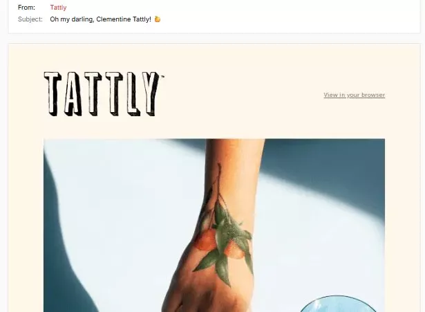 Funny email examples: A hand with a temporary tattoo of a clementine branch with leaves and small fruits is shown on a light background. The email header includes TATTLTY and the subject Oh my darling, Clementine Tattly! 👍.