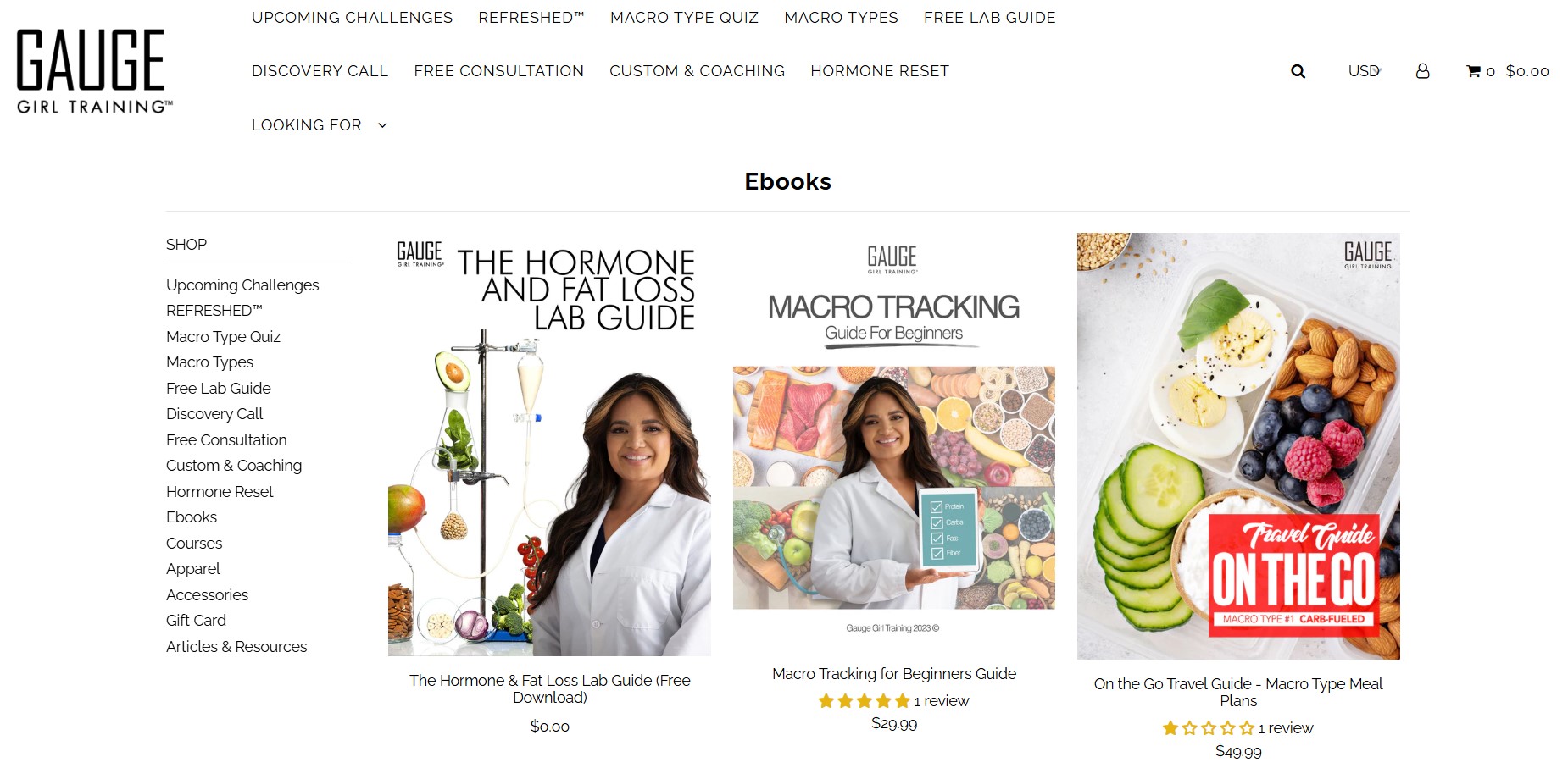 How to make money on Shopify: Screenshot of the Gauge Girl Training websites Ebooks section, displaying three ebook covers: The Hormone & Fat Loss Lab Guide, Macro Tracking for Beginners, and Travel Tips: Macro Type Meals On The Go.