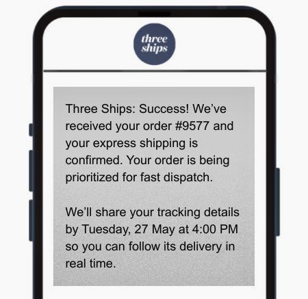 Order confirmation SMS: A smartphone screen displays a message from Three Ships confirming order #9577 with express shipping, stating the order is prioritized and tracking details will be shared by Tuesday, 27 May at 4:00 PM.