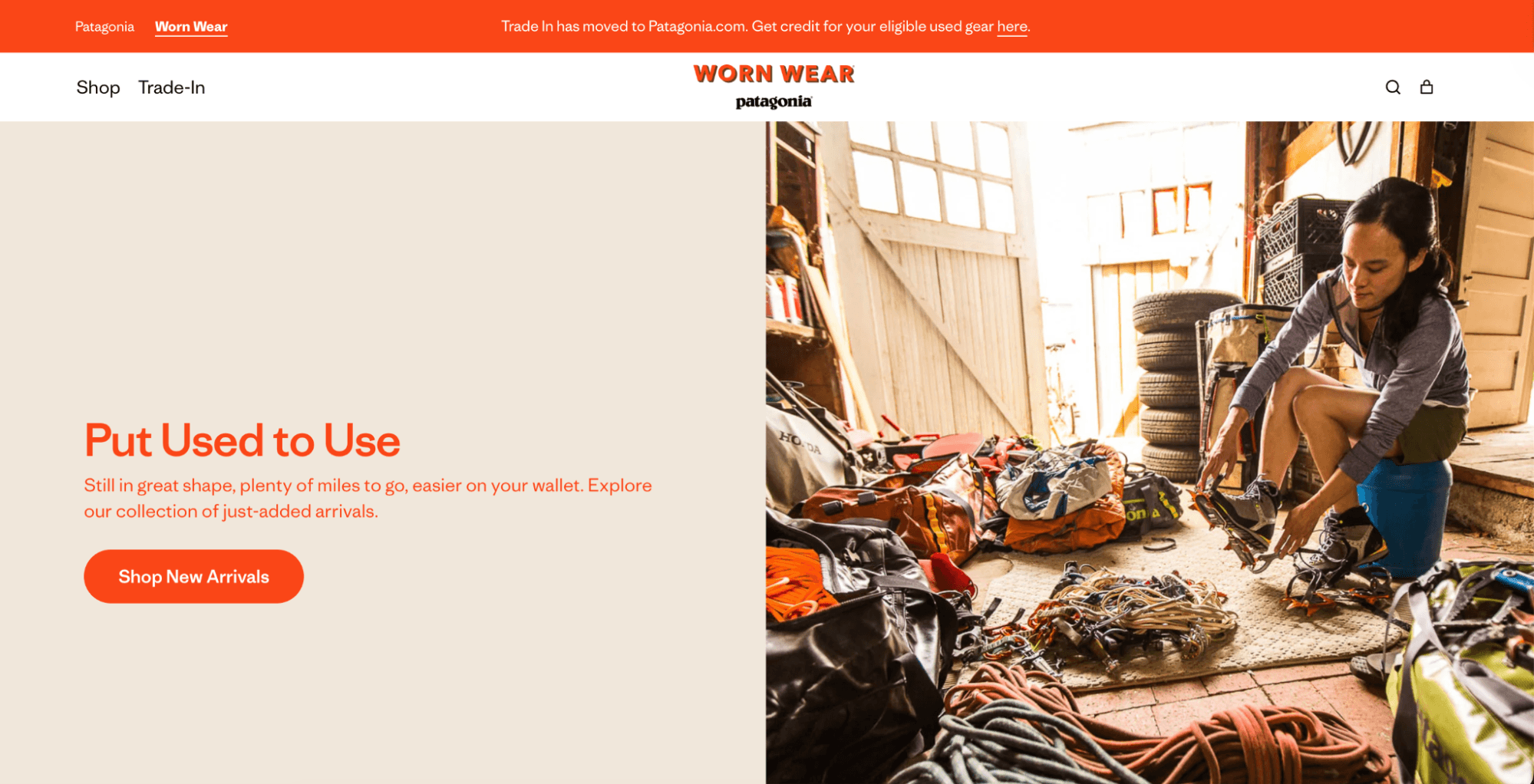 Loyalty programs: A woman kneels indoors, repairing gear surrounded by ropes and outdoor equipment. On the left, text promotes buying used outdoor items, and an orange button reads Shop New Arrivals. The top banner is orange with navigation links.