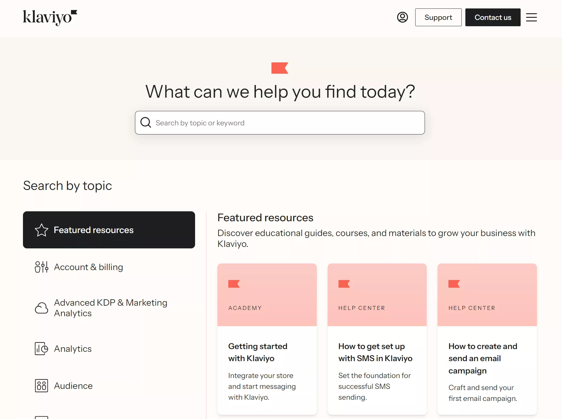 Omnisend vs. Klaviyo: Klaviyo support page with a search bar, sidebar menu on the left, and featured resources cards in the center. The featured resources include guides on SMS setup and email campaigns.