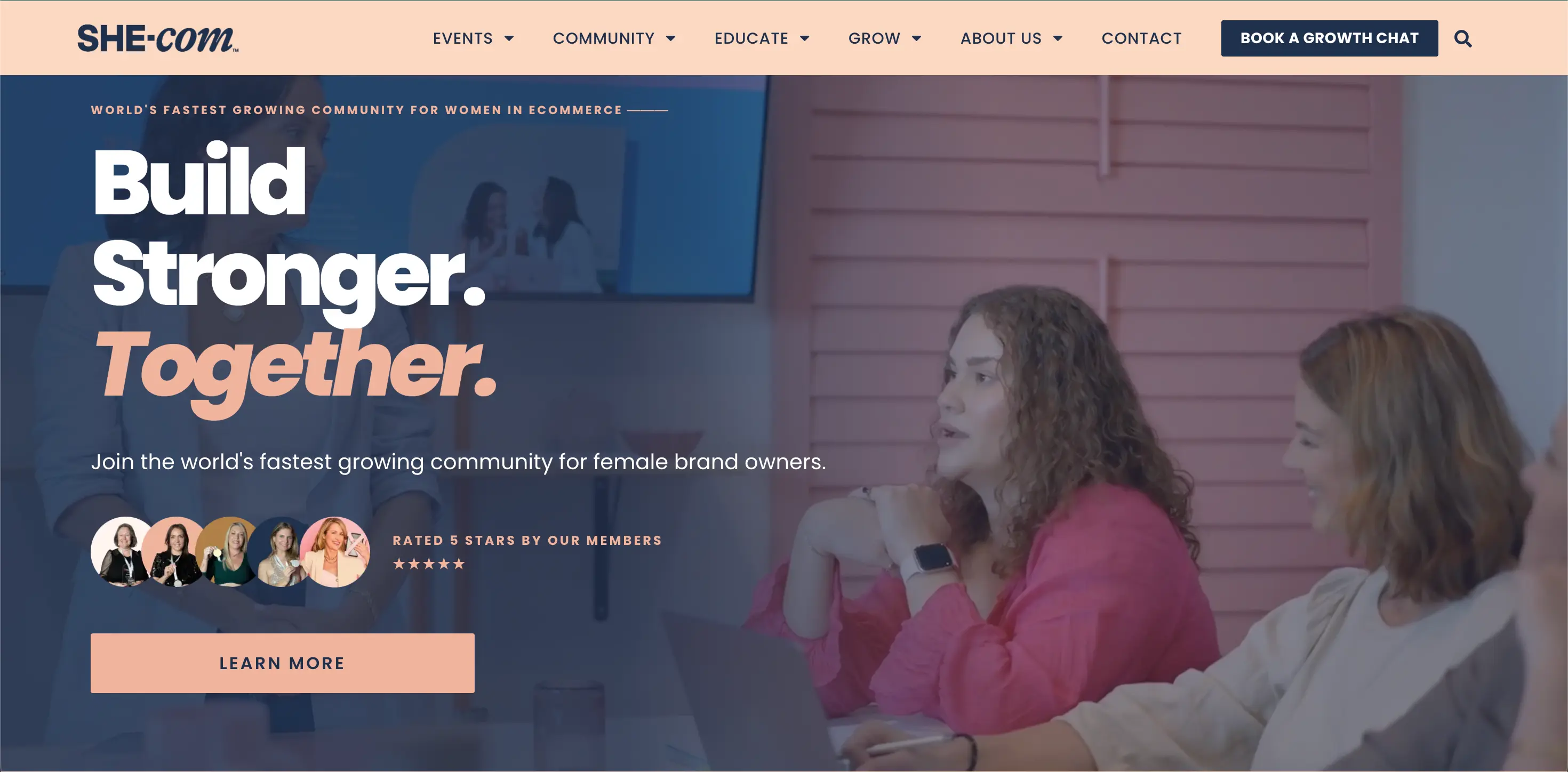 Ecommerce community: Two women work on laptops at a conference table, with Build Stronger. Together. text overlaid, promoting SHE-com, a community for female brand owners in e-commerce. Pink background with wall art and shelves.