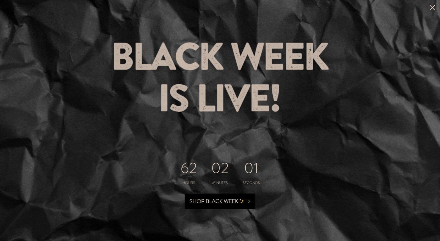 Black friday popup: Crumpled black paper background with large beige text that says BLACK WEEK IS LIVE! and a countdown timer below showing 62 hours, 2 minutes, and 1 second. A Shop Black Week button is at the bottom.