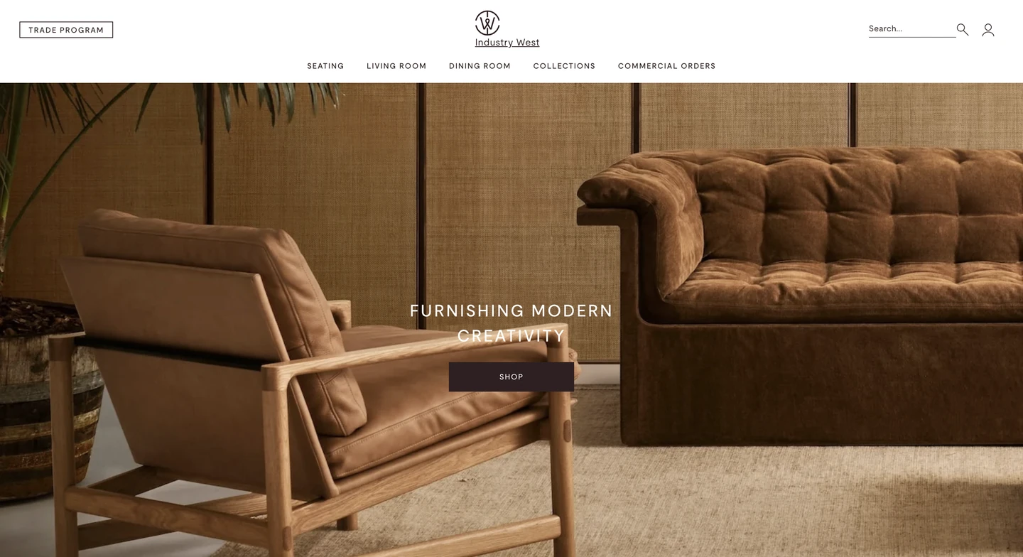 Brown modern chair and sofa in a minimalist living room setting with wood and woven panel backdrop.
