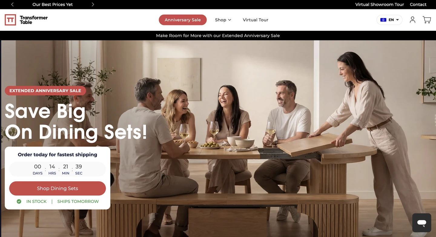 Five adults enjoy a meal and conversation around a wooden dining table in a bright, modern room.