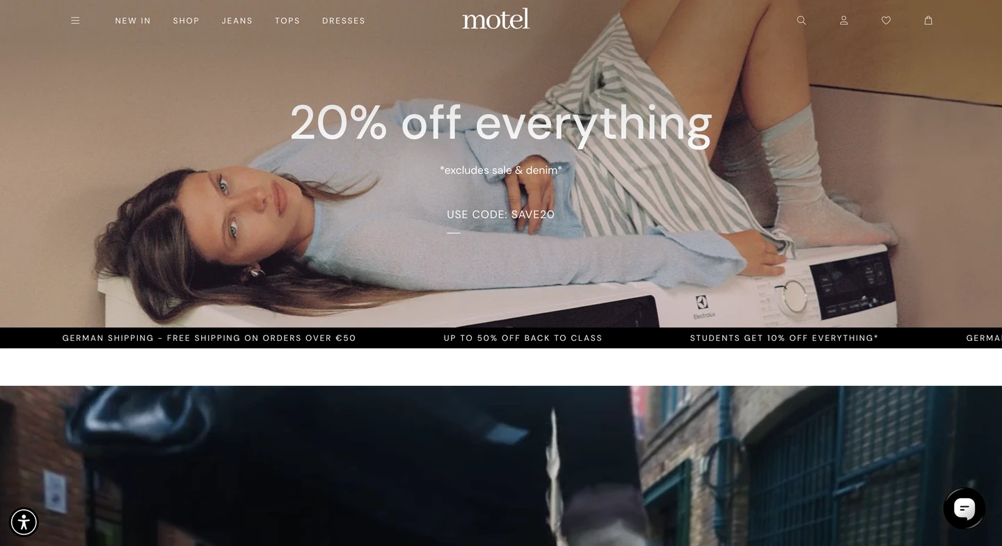 Woman lying on a washing machine above text advertising 20% off everything sale on Motel clothing website homepage.