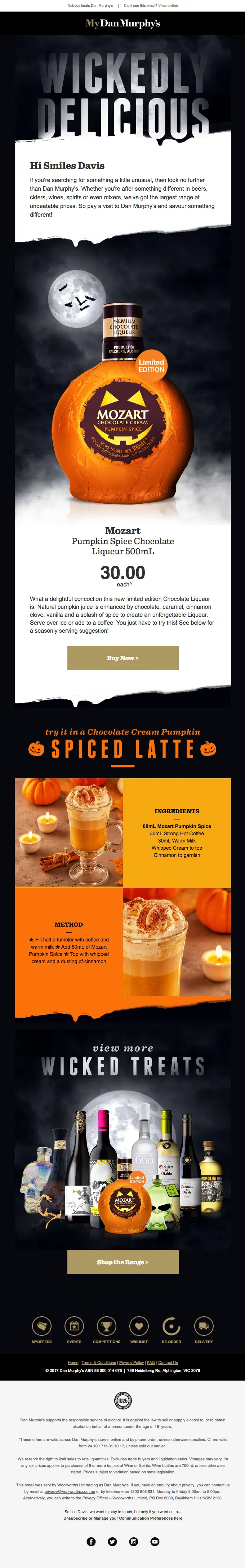 A bottle of Pumpkin Spice liqueur sits inside a carved pumpkin, with cocktails and ingredients nearby.