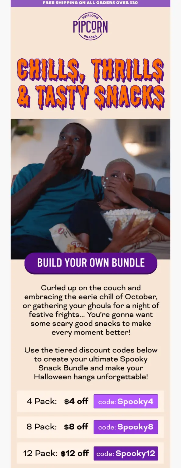 Two people sit on a couch eating popcorn, with a Halloween-themed snack promotion and discount codes displayed below.
